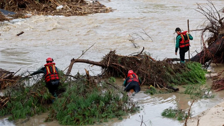 Spain floods: Boy survives by clinging to tree overnight