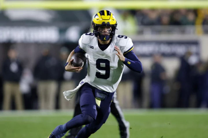 McCarthy throws 3 TD passes in 1st half, No. 2 Michigan routs Michigan State 49-0