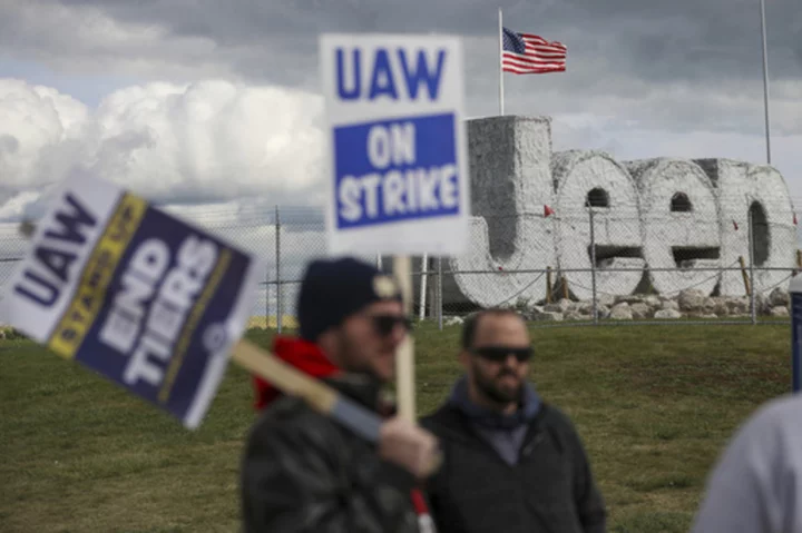 Auto workers escalate strike, walking out at Ford's largest factory and threatening Stellantis