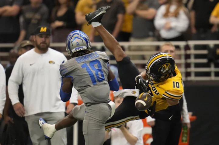 Luther Burden III hauls in 10 passes for 177 yards to help Missouri beat Memphis 34-27 in St. Louis