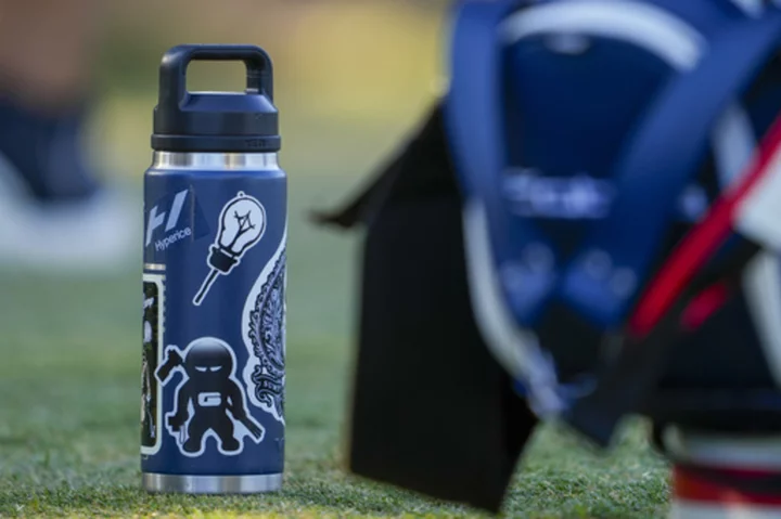 Stickers adorn Rickie Fowler's ever-present water bottle at US Open