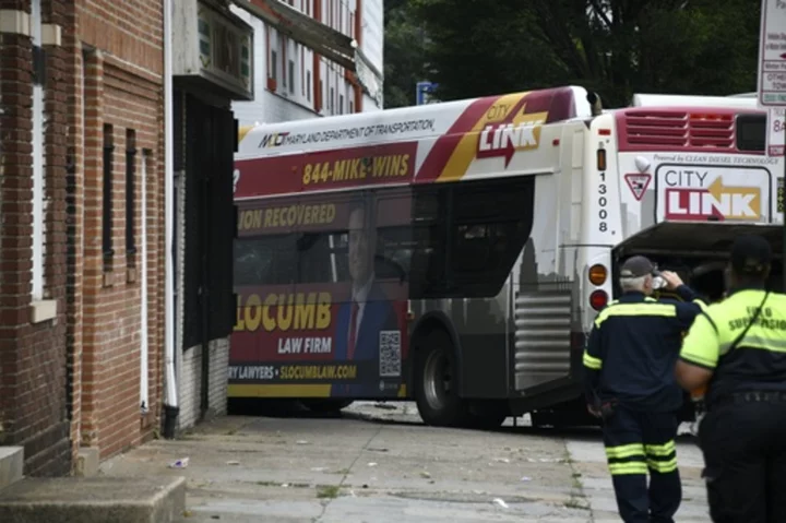 16 injured as Baltimore bus crashes into 2 cars, apartment building