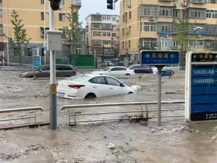 Heaviest rain in a decade kills 11 in Beijing as raging torrents wash away roads and cars