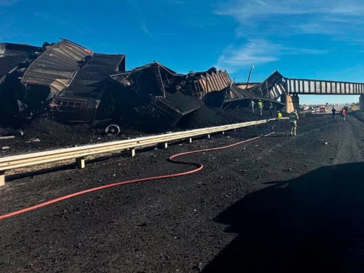 Coal train derails off Colorado bridge and onto interstate, killing a semi truck driver, authorities say