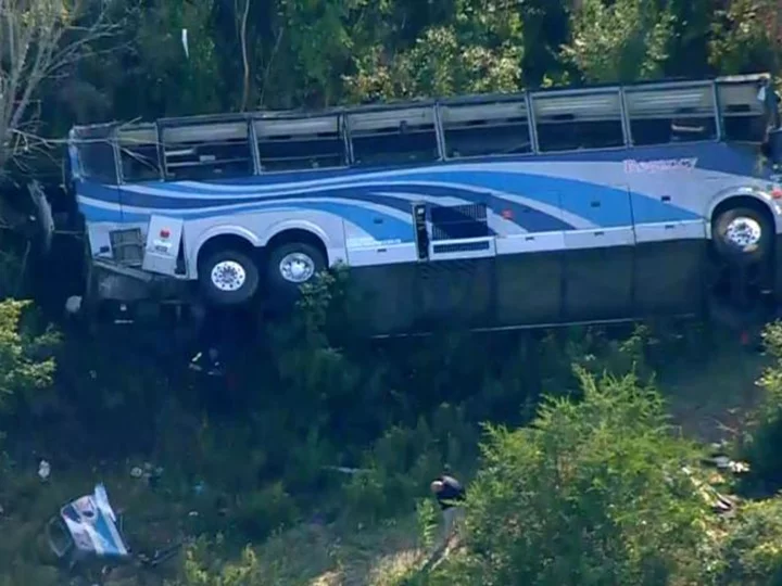 Officials begin probe into what caused a bus carrying 40 students to crash down a ravine, killing 2 adults