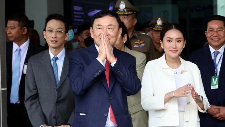 Thaksin: Former Thai PM's prison sentence reduced to a year