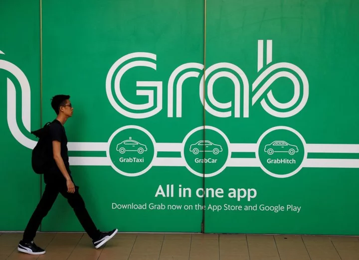 Grab sets free cash flow target, posts first adjusted core profit