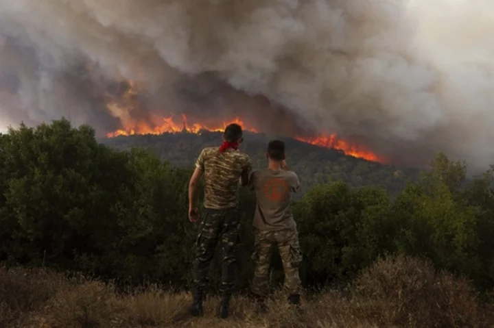 Greece reinforces firefighting forces as a massive wildfire in the northeast burns for a 13th day