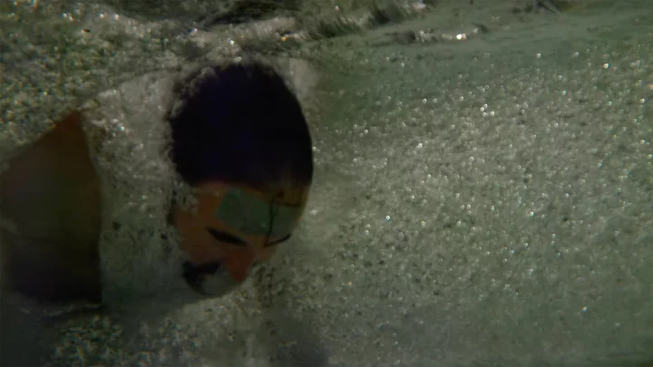 Man dives head-first through a giant water balloon in glorious slow motion