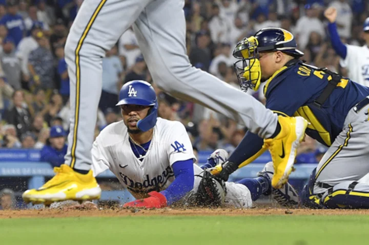 Two catcher's interference calls help Dodgers beat Brewers 7-1 for 10th straight win