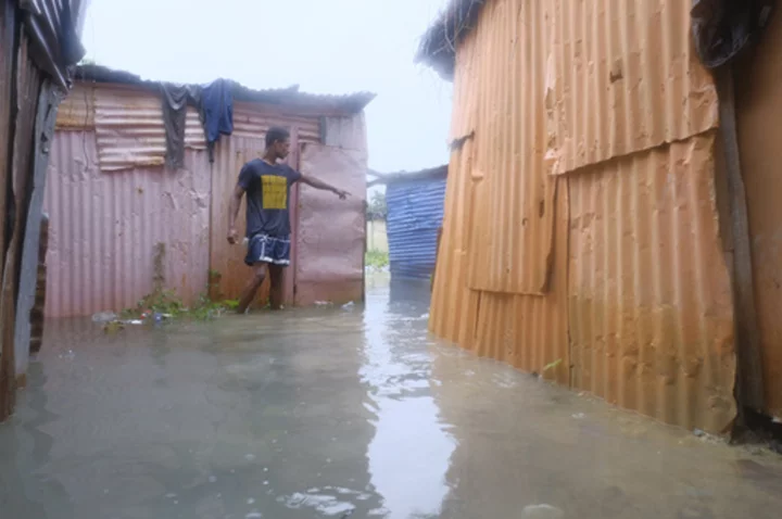 Dominican officials inspect damage inflicted by Tropical Storm Franklin after heavy flooding kills 2