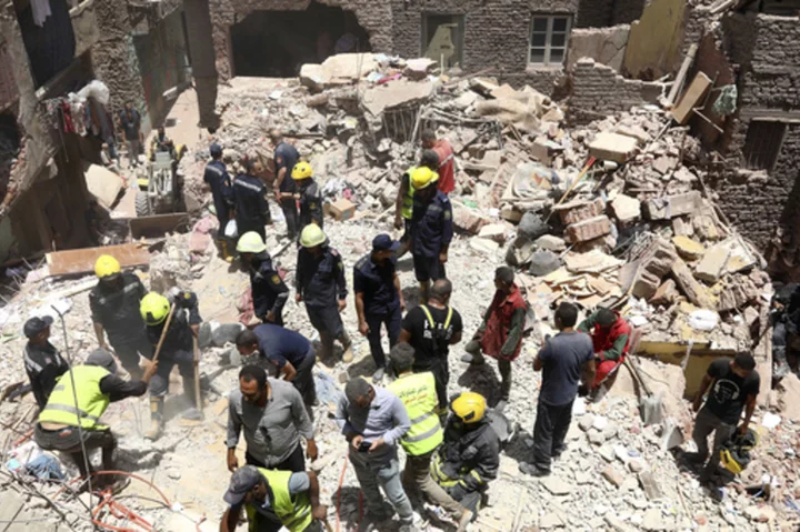 A 5-story apartment building collapses in Cairo and kills at least 12 people, with two missing