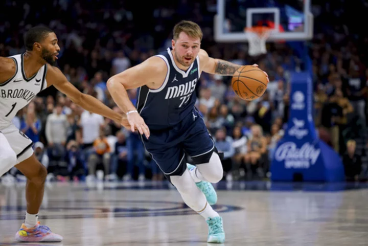 Doncic scores 49 and hits a late right-handed 3-point heave as the Mavericks beat the Nets 125-120