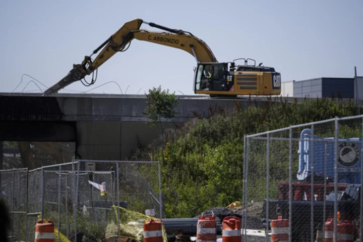 In the effort to reopen I-95 in Philadelphia, crews get some help from a NASCAR fan